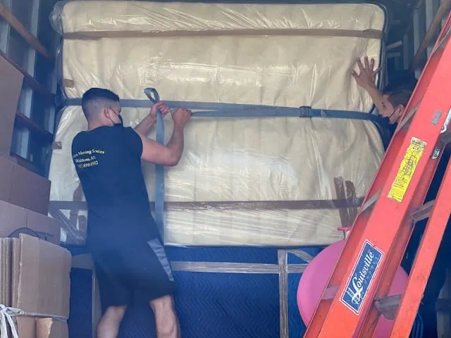 Family happily moving into a new home with professional movers